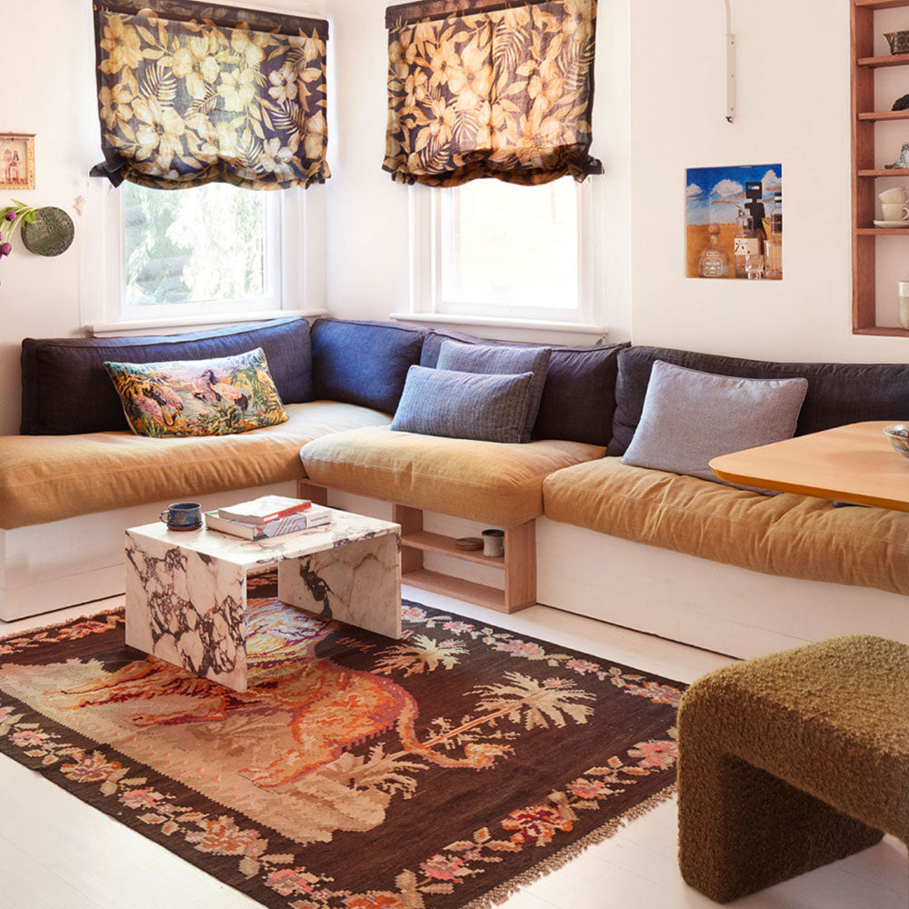 Small Floral handwoven rug in living room with coffee table, sofas, curtains, cushions, and painting