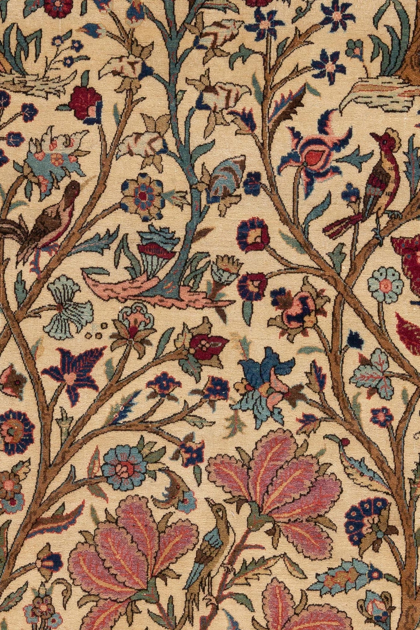 Close-up of a detailed floral and bird pattern of Antique Persian Kashan rug