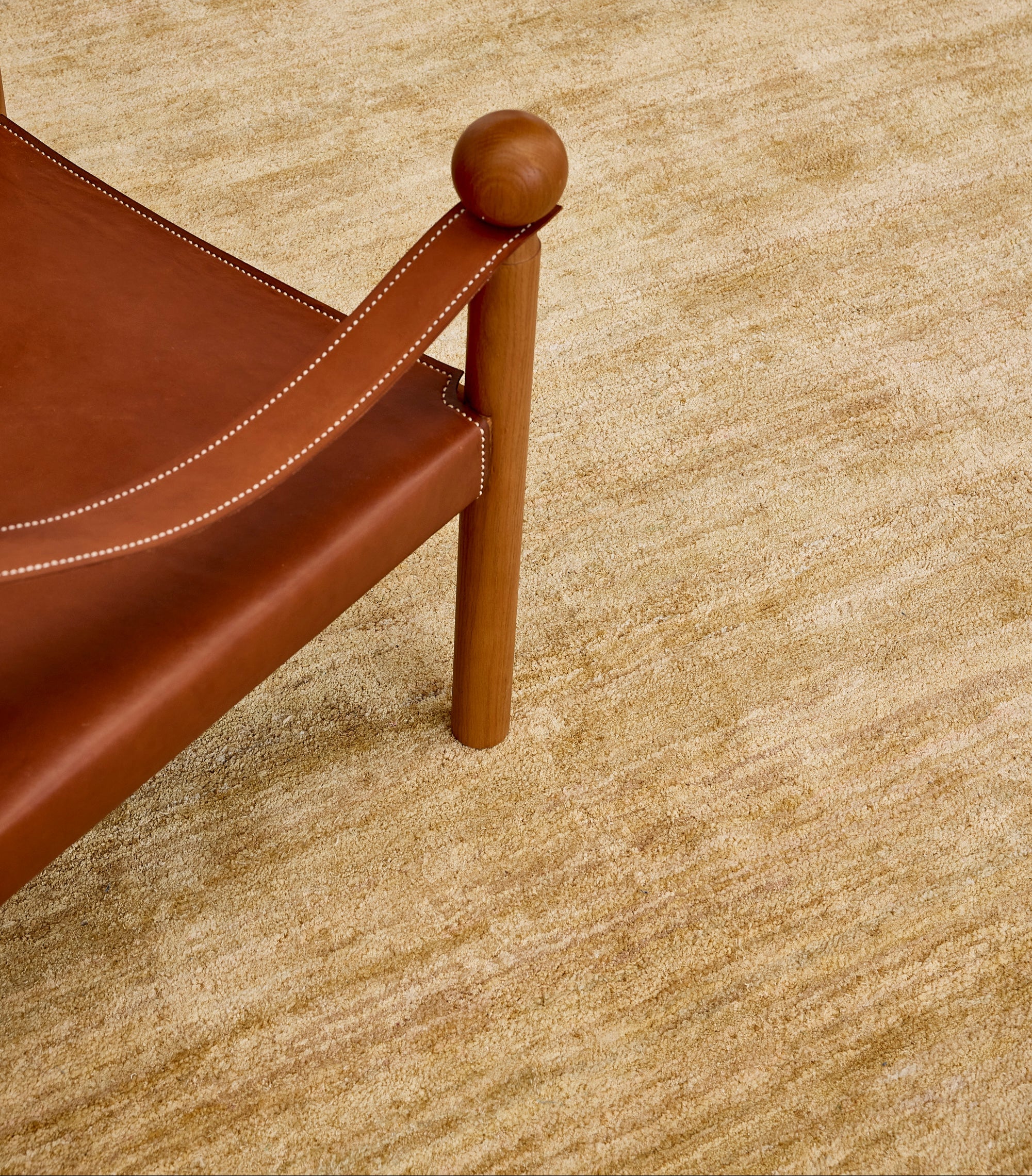 Samite Gold Abrash Silk Rug with leather chair