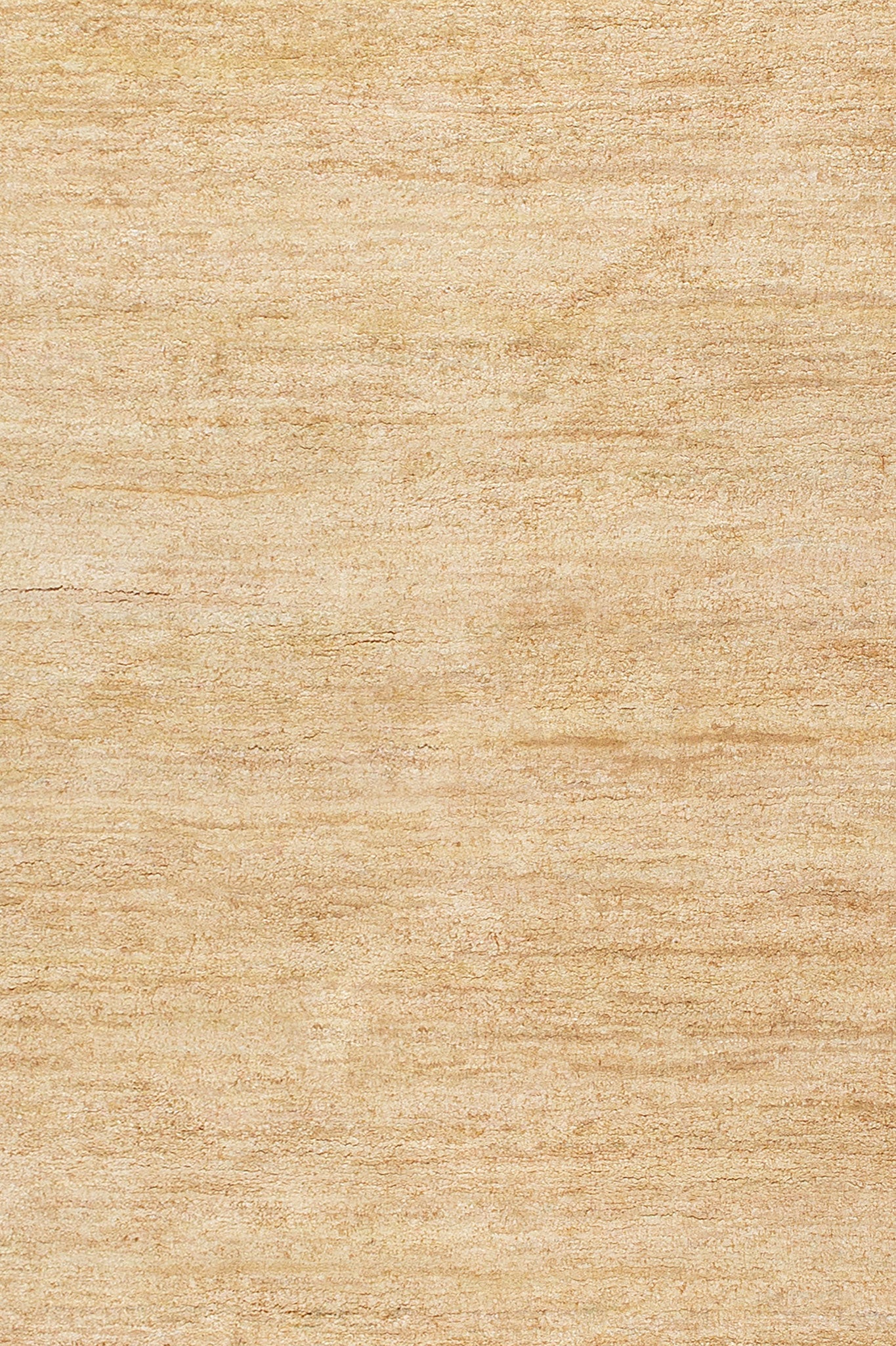 Close-up texture shot of a beige woolen rug with hand-knotted design.